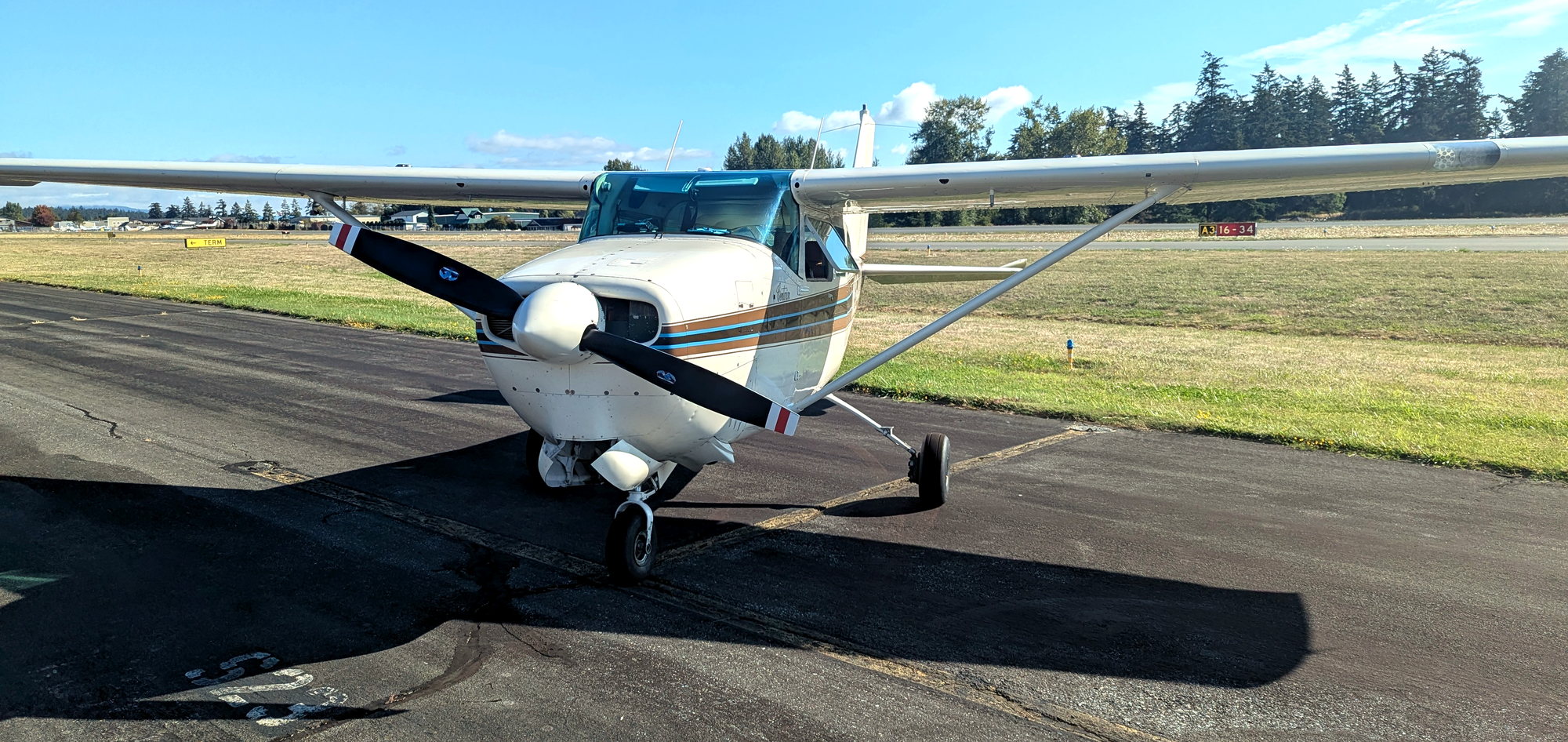 Front view of B&B Aviation's Cessna 210B N9544X on the Arlington airport ramp